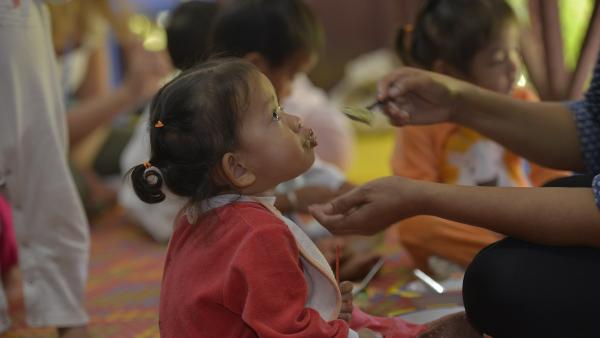 A little girl is fed at the PSE nutrition center