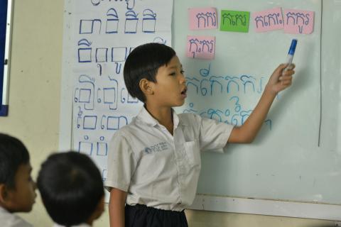 Un élève au tableau fait un exercice à l'école de rattrapage de Pour un Sourire d'Enfant