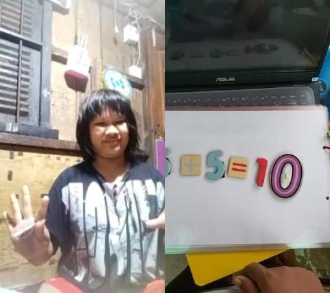Une petite fille porteuse de handicap réalise un exercice de mathématiques avec son éducatrice en visio Une petite fille porteuse de handicap réalise un exercice de mathématiques avec son éducatrice en visio